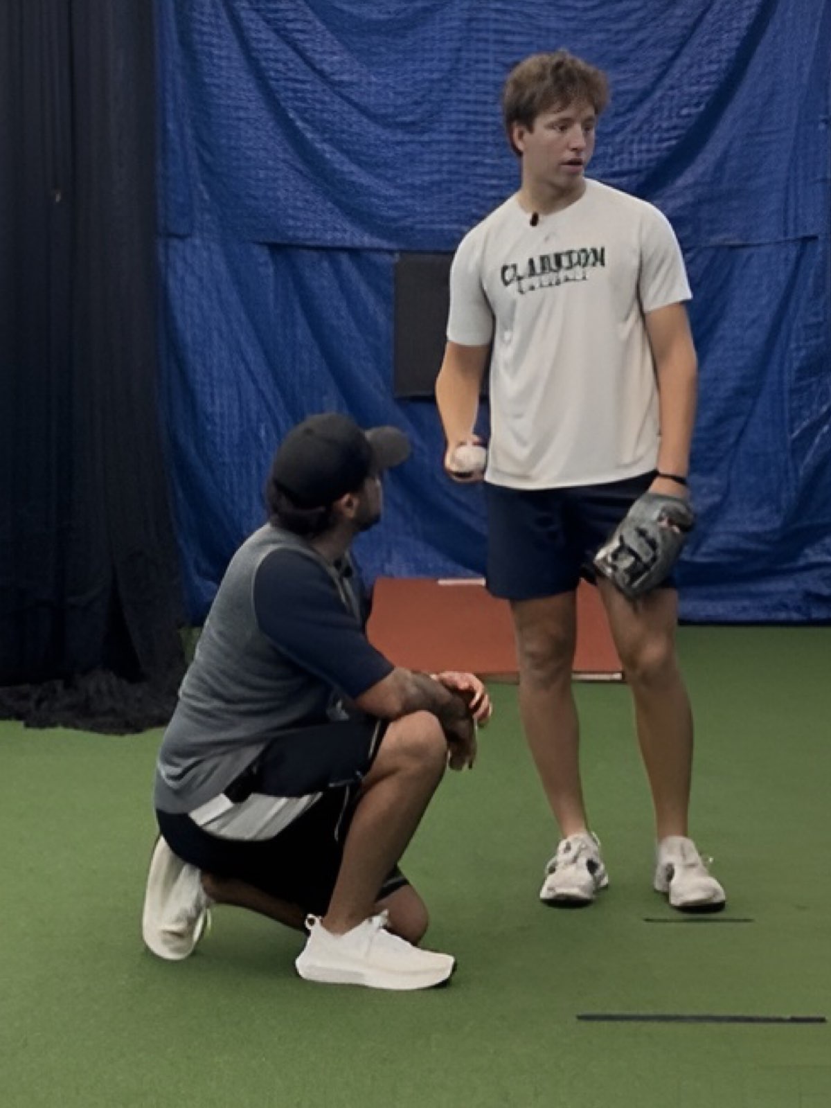 CJ coaching a pitcher during a training session